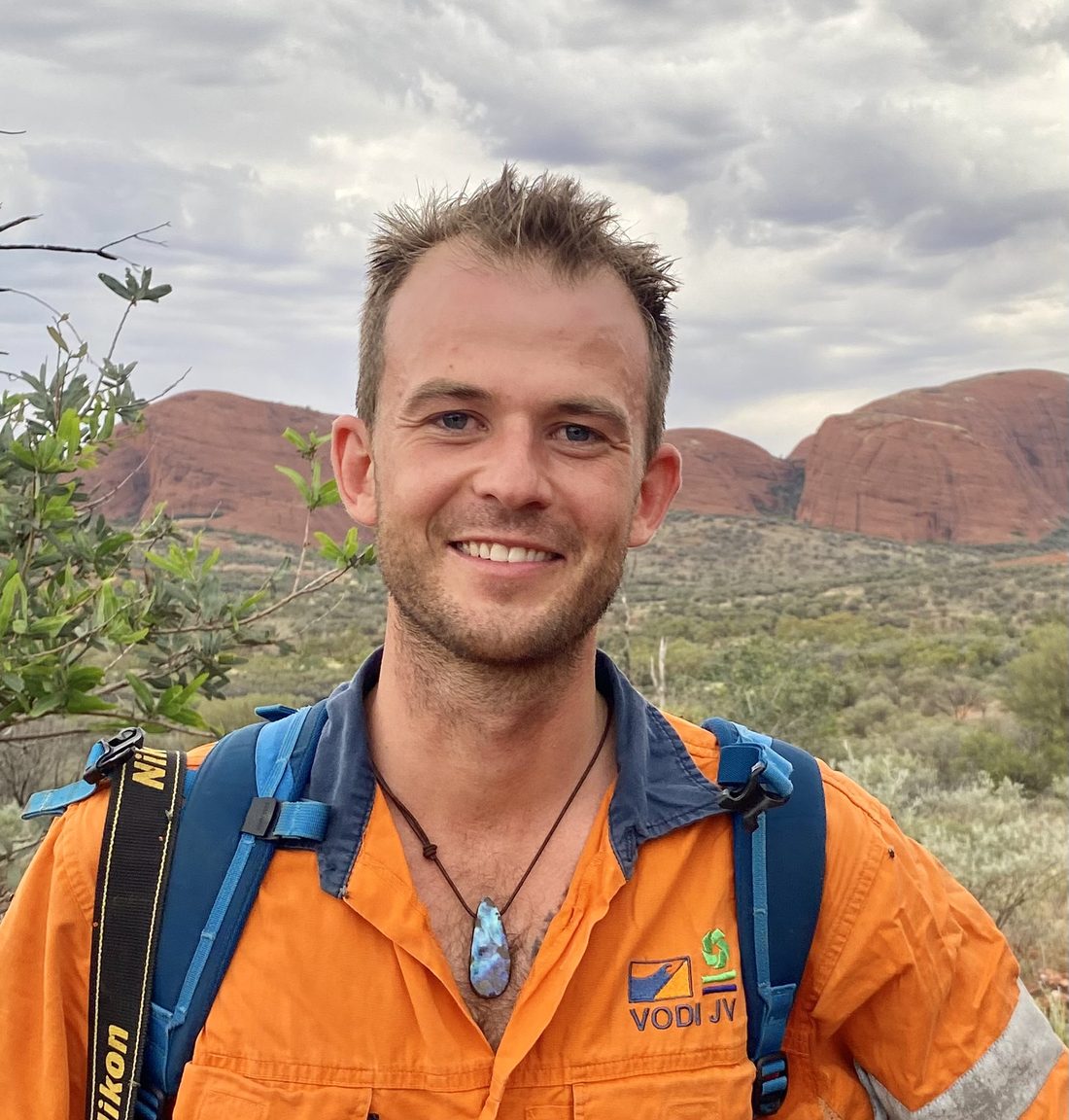 Barney Swan in a work shirt, red rock country behind